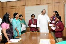 Chief Minister Shri Naveen Patnaik presenting Rs 1 lakh cash award each to bravery award winners Srimati Badra, Purnima Giri and Sabita Giri at Lok Seva Bhawan