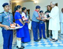 Students Pinning  Bharat Scouts and Guides Flag to Chief Minister Shri Naveen Patnaik at Naveen Niwas